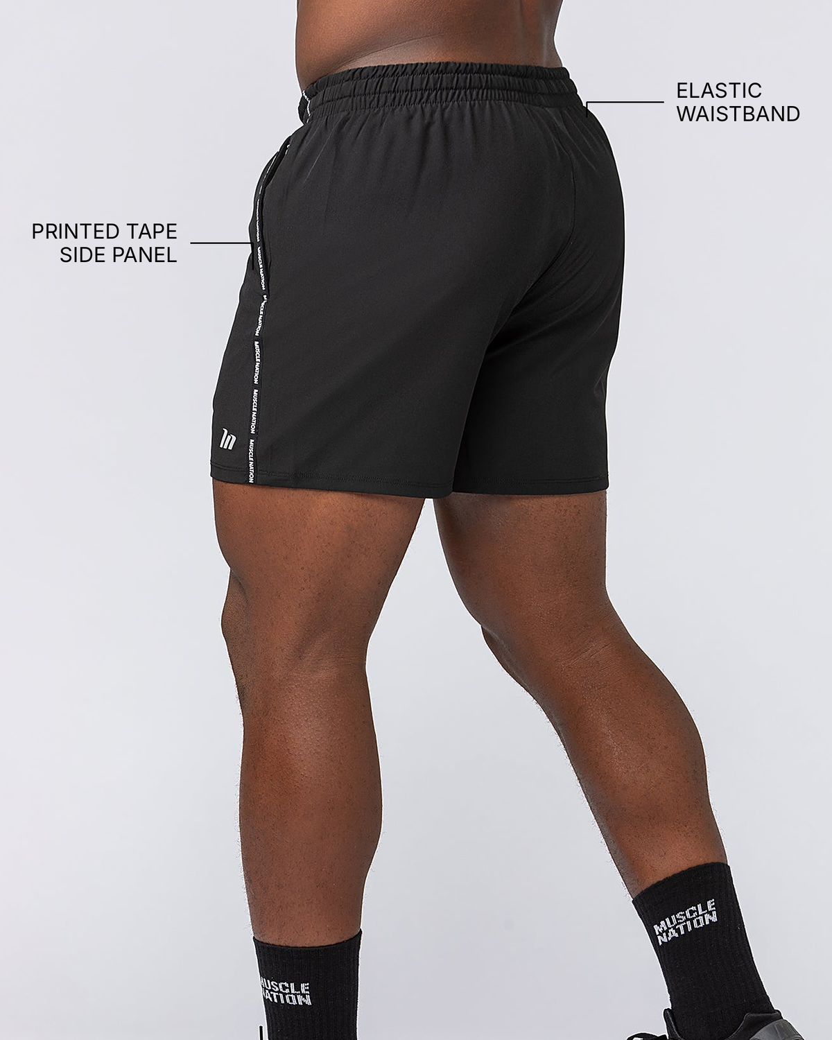 Iconic New Heights 4" Shorts - Black - Muscle Nation feature callouts: printed tape side panel, elastic waistband