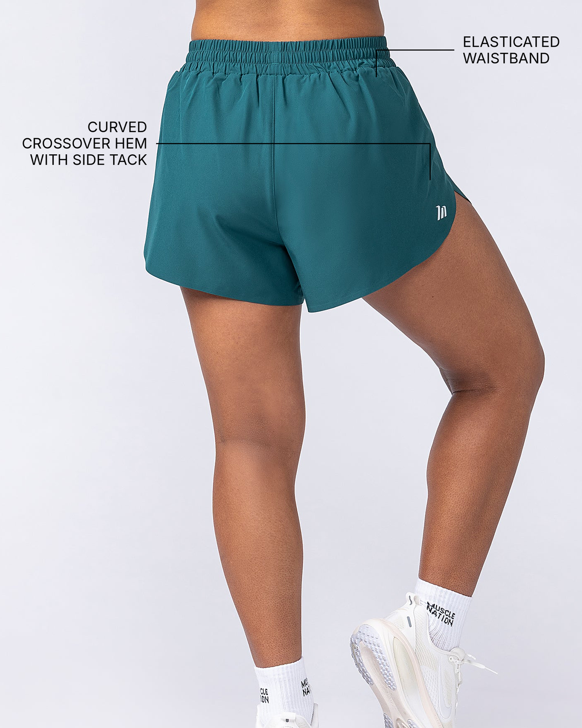 Pace 3" High-Waisted Run Shorts - Hunter Green - Muscle Nation feature callouts: elasticated waistband, curved crossover hem with side tack